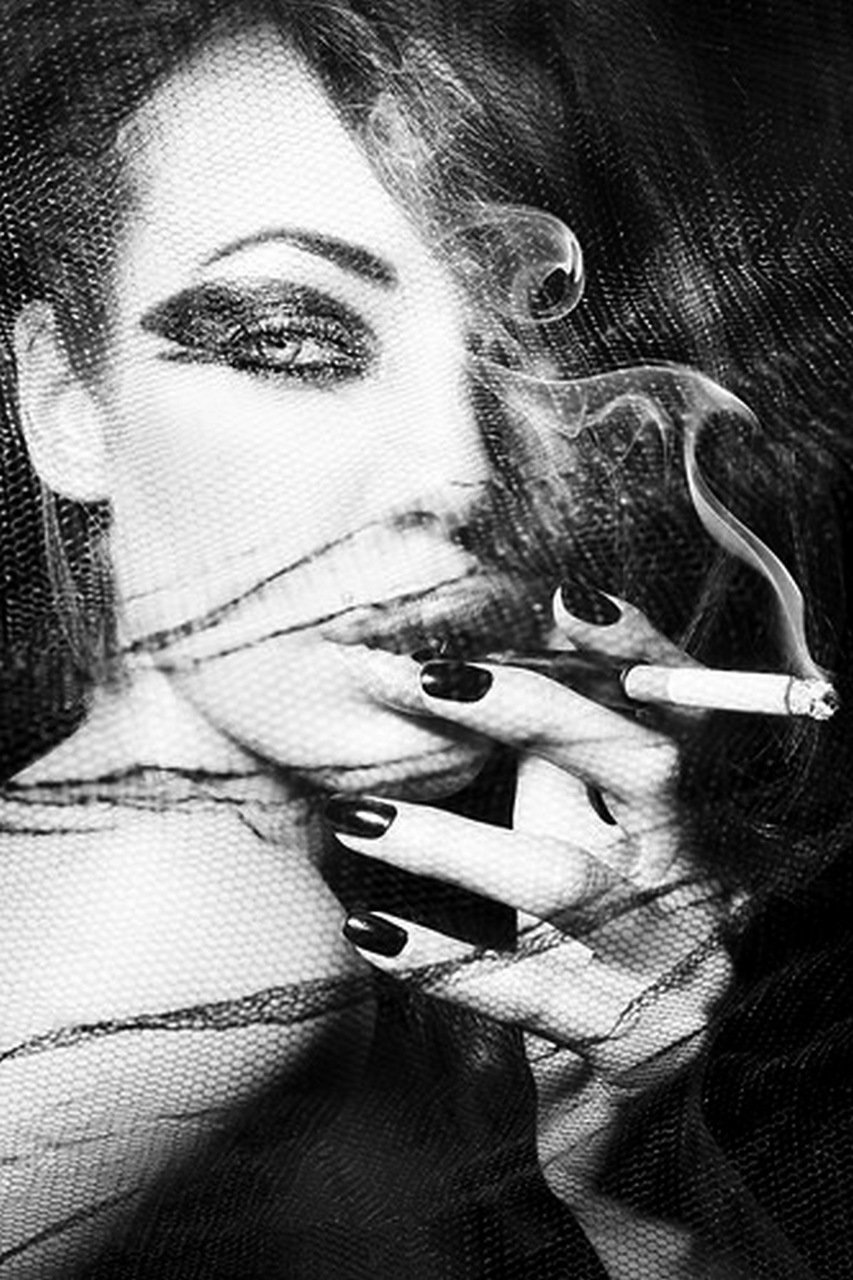 Tattooed girl smokes