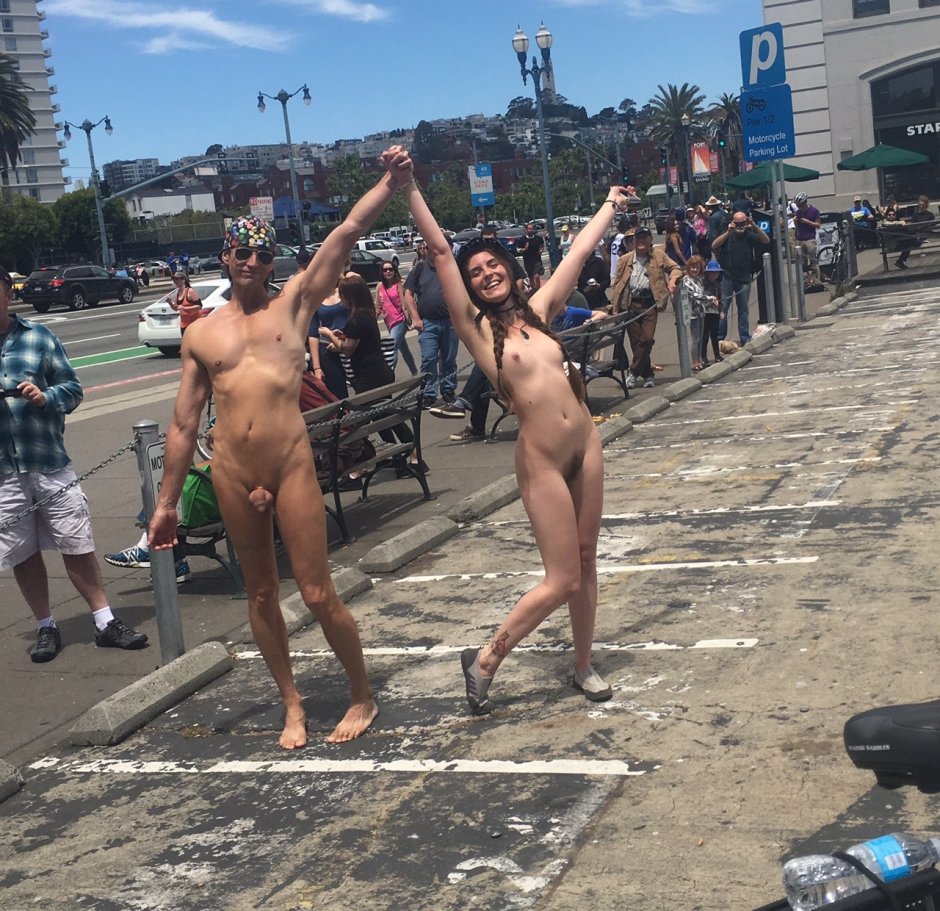Naked girls walk along the street