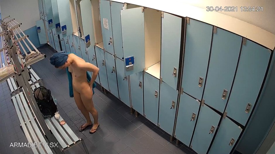 The girl undresses in the locker room