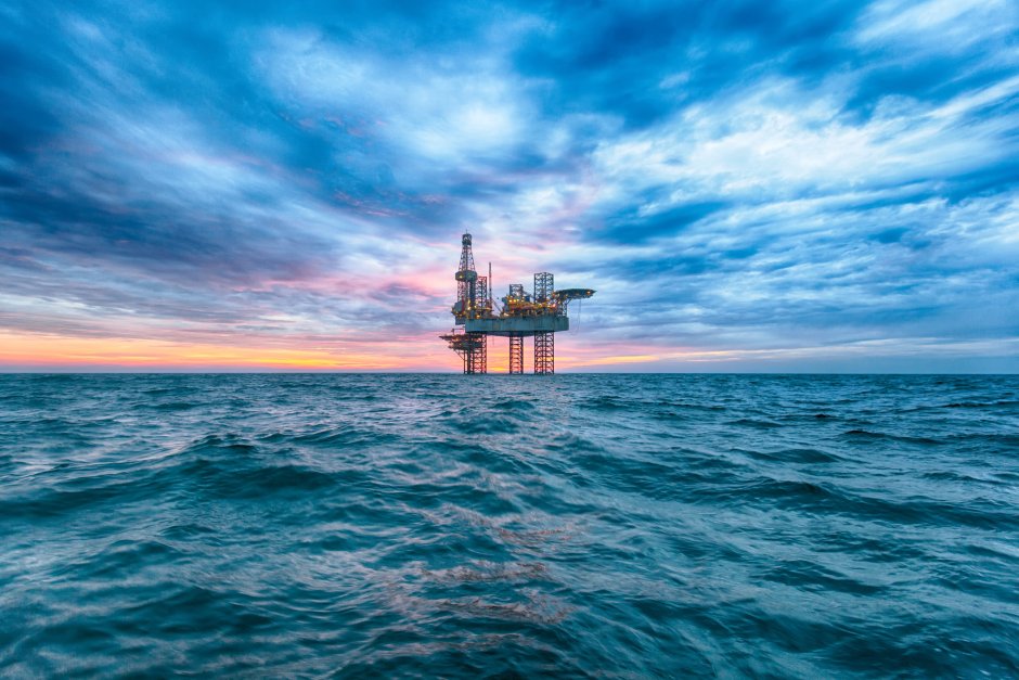 Oil tower in the sea sunset