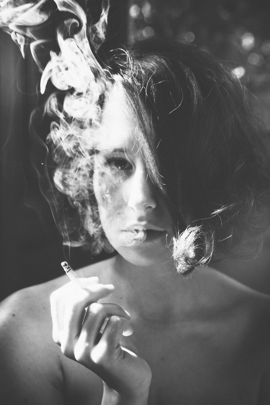 An elegant woman smokes