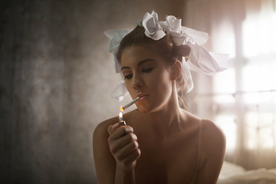 The girl smokes a cigarette with a mouthpiece