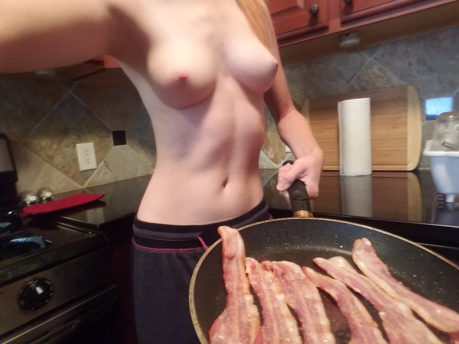 The girl undresses in the kitchen