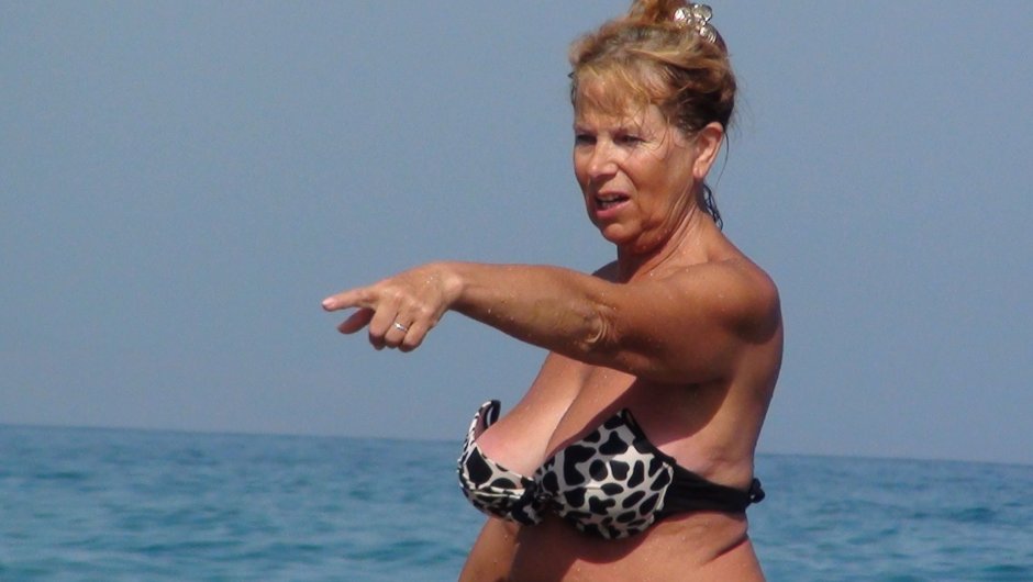 Mature in bikini naked on the beach