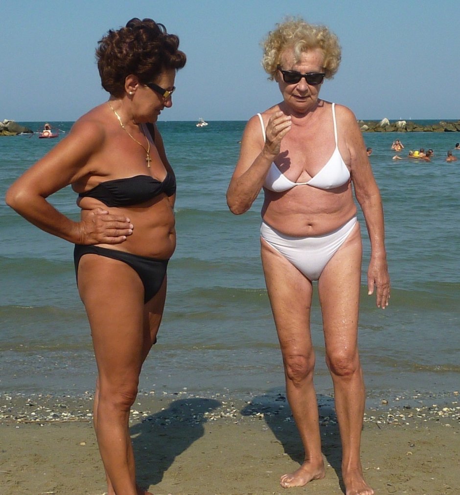 Mature women in swimsuits sunbathe