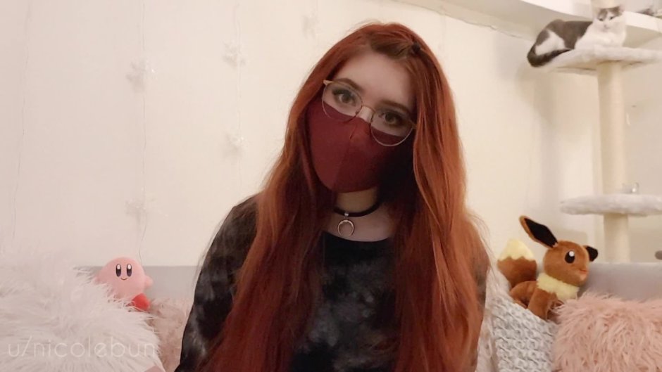 Red -haired girl in glasses tries