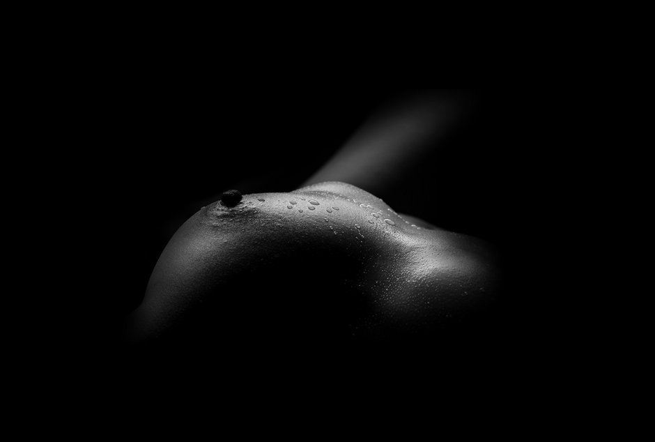 Erotic photo shoot on a black background