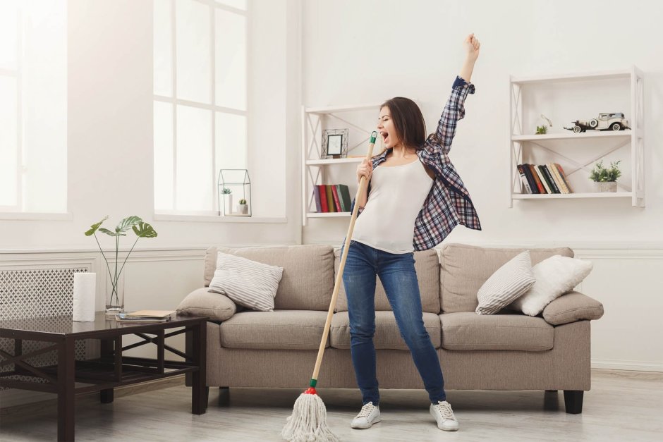 The girl puts things in order in the house