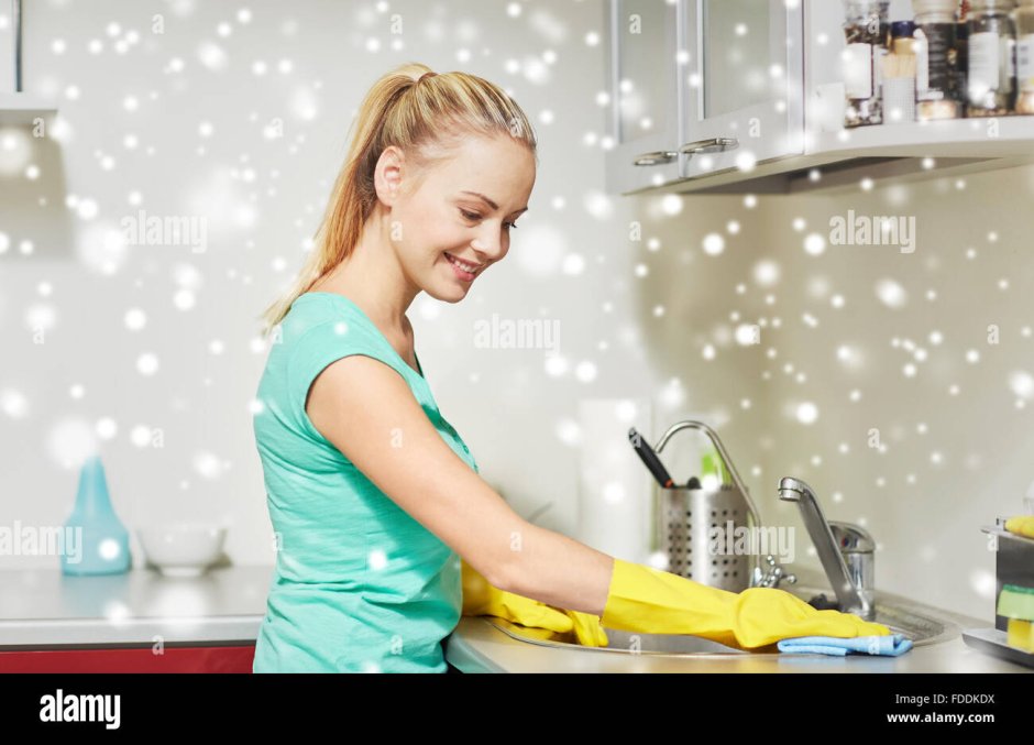 Woman wipes the kitchen table
