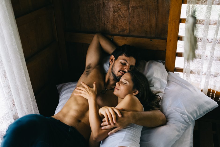 A guy with a girl in bed