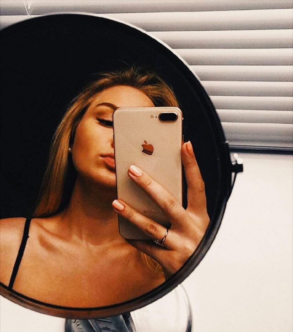 Girl with iPhone in the mirror