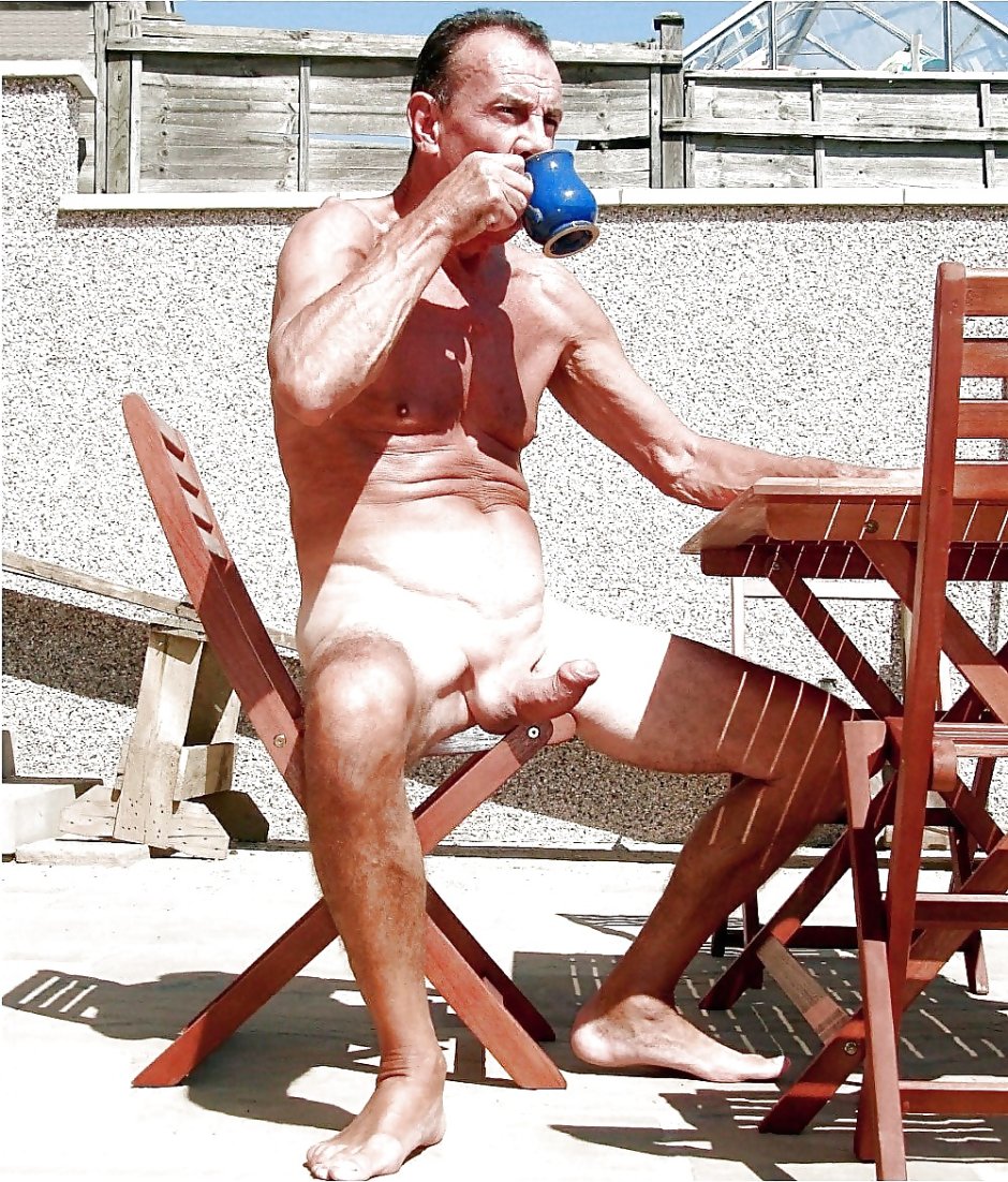 Naked man with piercing on the beach