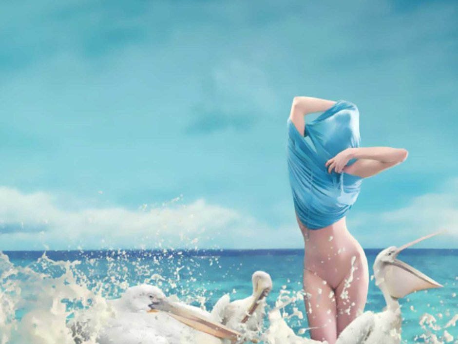 The girl is walking along the shore