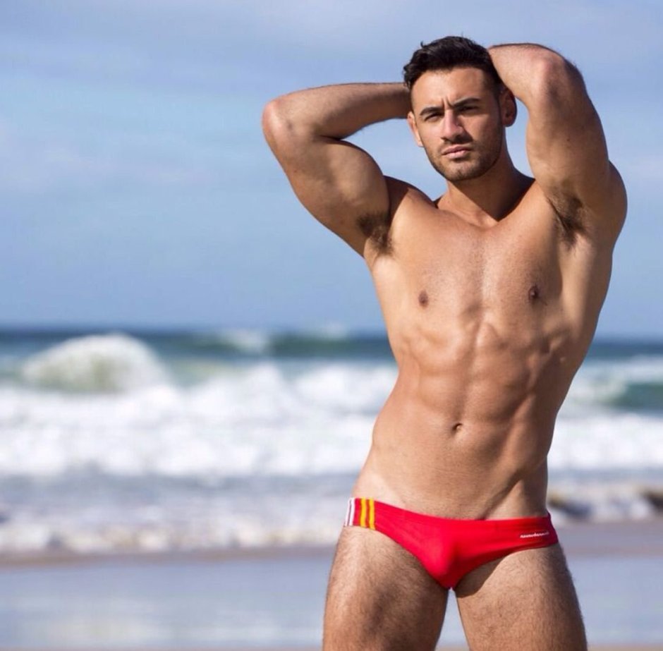 Men in swimming trunks on the beach
