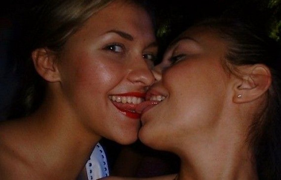 Girls kiss each other's breasts