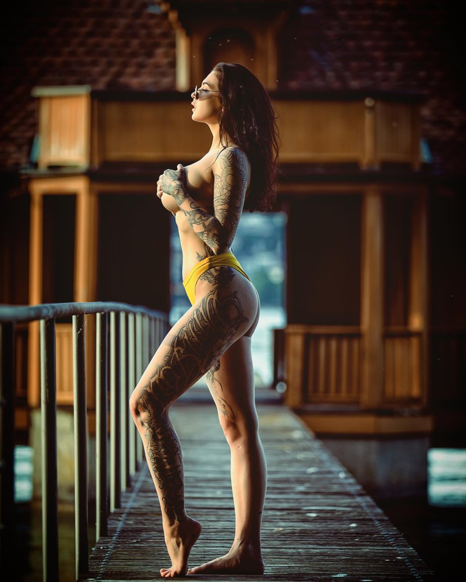 Naked posing in a chair