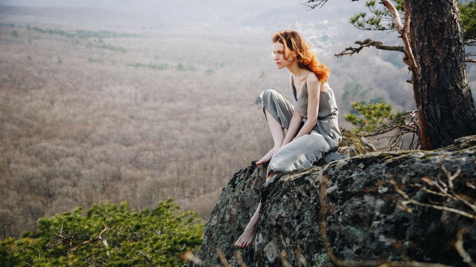 Girl sits on a stone