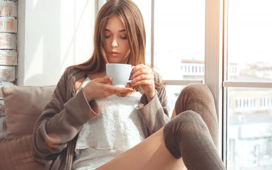 The girl drinks coffee