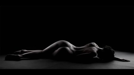 Naked woman on a black background