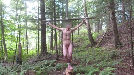 Naked in the forest with tied hands