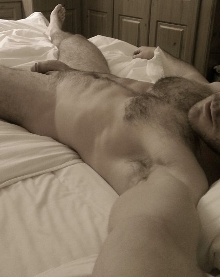 Hairy guy on the bed naked