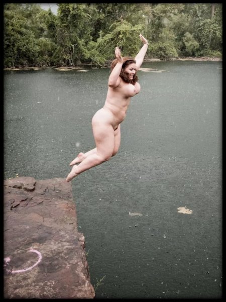 Naked women jumping in the water