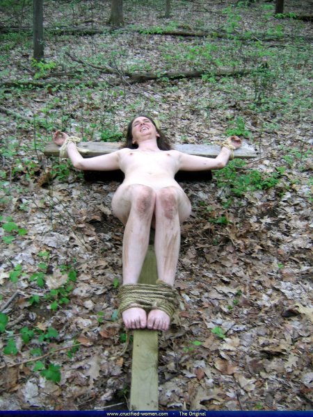 Naked crucified in the forest