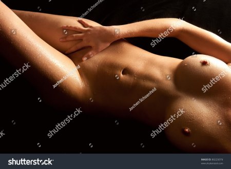 Portrait of an attractive nude woman with wet body by Jochen Schoenfeld