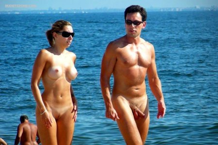 Naked women among men on the beach