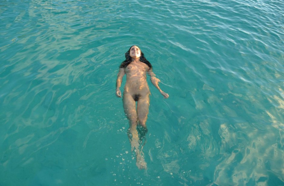 Naked women swim in the sea