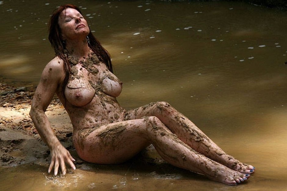 Naked women are lying in mud