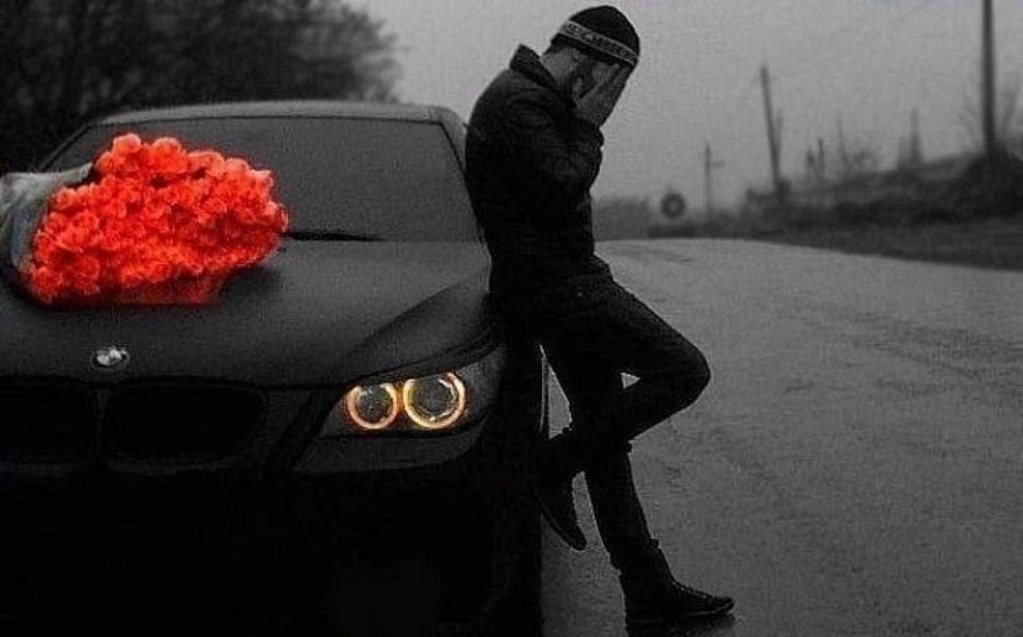 Man with flowers near the car