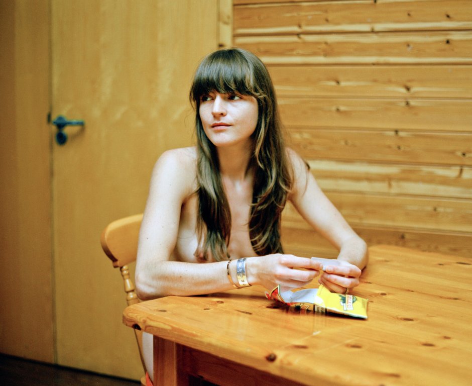 Young nudists in the kitchen