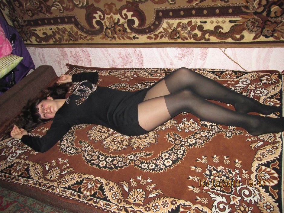 Woman against the background of carpets