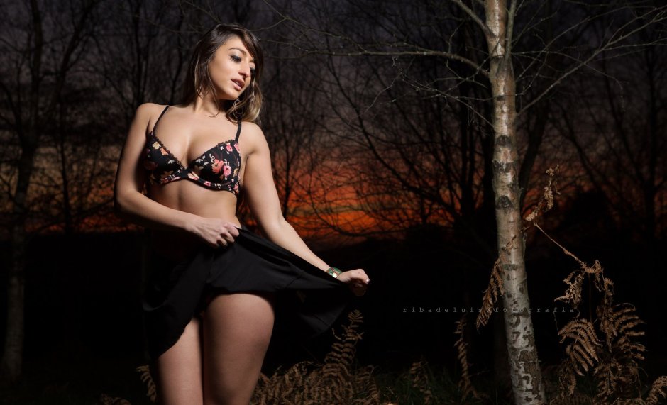 The girl undresses in the forest