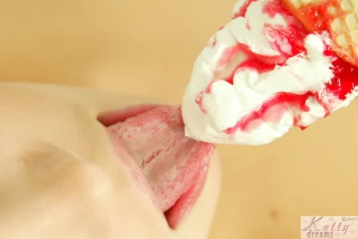 Девушка облизывает мороженое