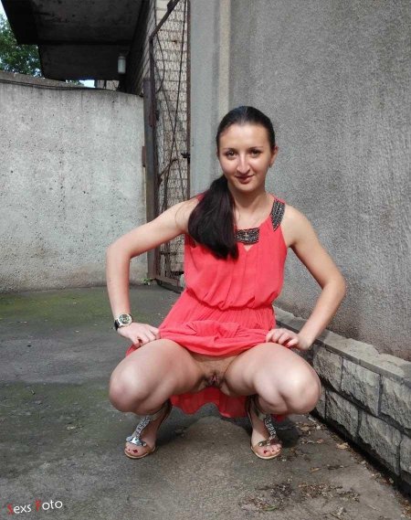 Naked woman squatting with her legs spread