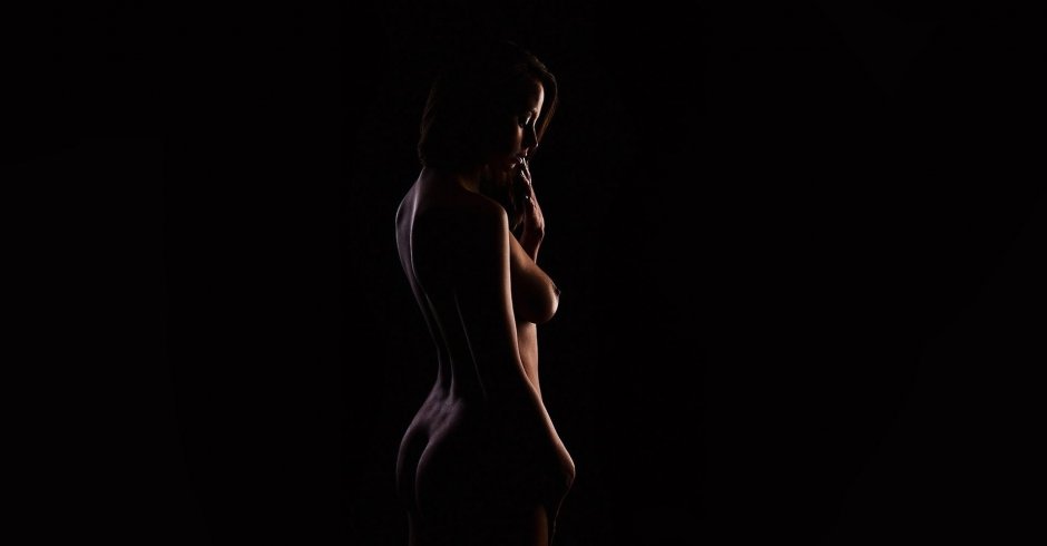 Ню голая в полный рост на темном фоне цветы в волосах