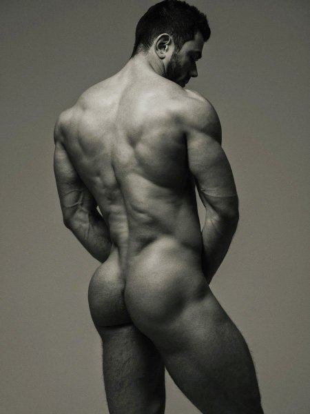 A guy’s naked butt against the background of field