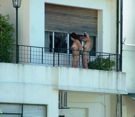 Naked women in the windows of houses