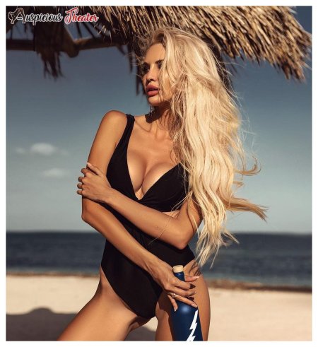 Beautiful sexy woman with blond hair in a luxurious swimsuit