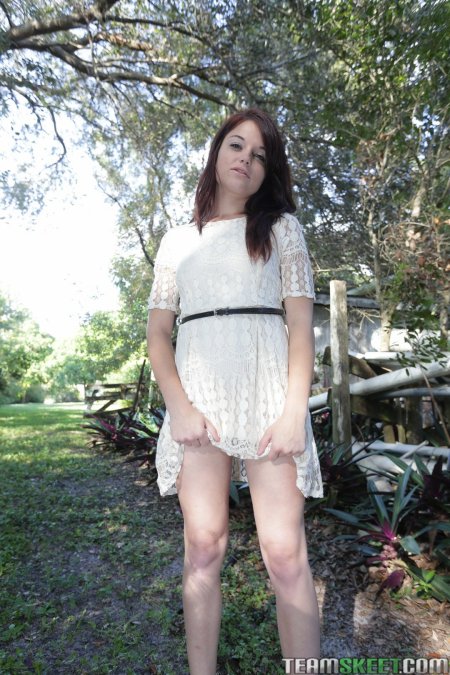 Kylie in sheer white dress outside