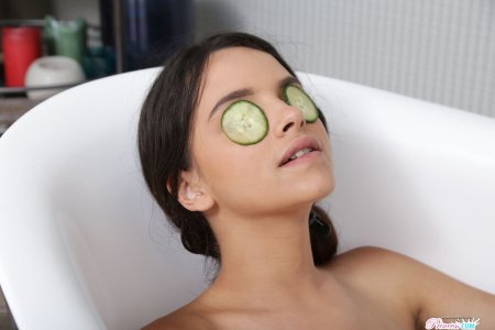 Woman at spa with cucumber slices covering her eyes