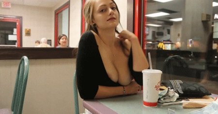Girls show their breasts in a cafe