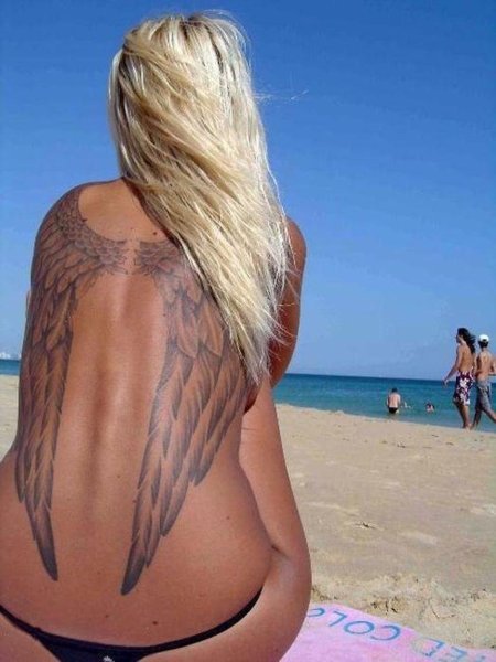 Wings tattoo on the back of a girl